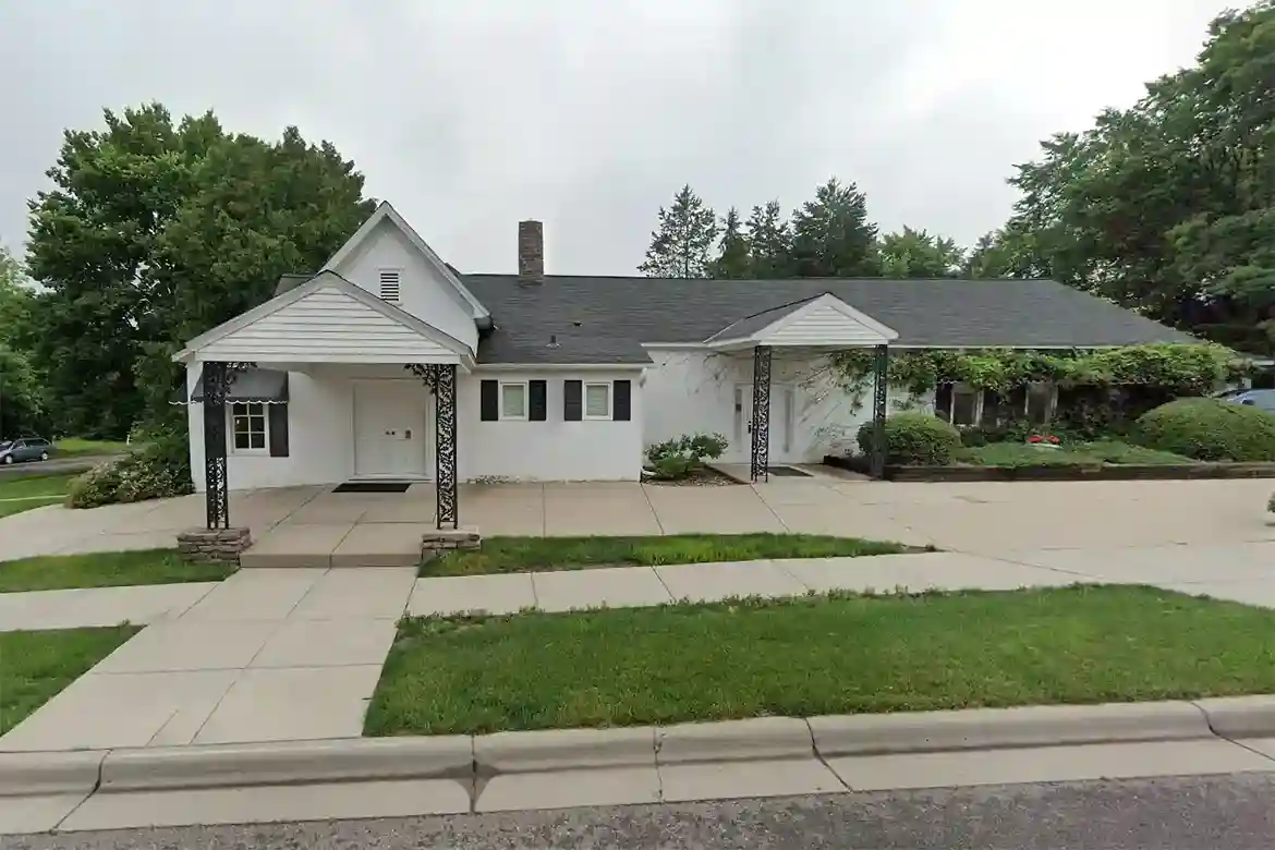 A peaceful and comforting image of Iten Funeral Home Delano MN, showcasing the funeral home's warm and welcoming exterior with a serene atmosphere.