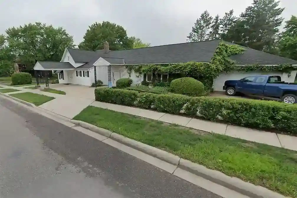 A peaceful and comforting image of Iten Funeral Home Delano MN, showcasing the funeral home's warm and welcoming exterior with a serene atmosphere.